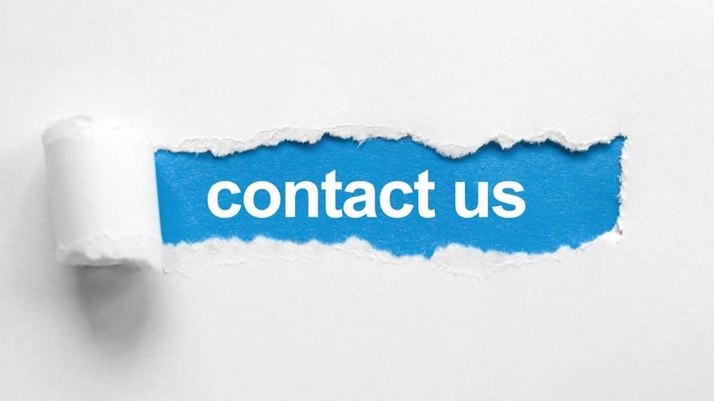Torn paper revealing blue background with 'contact us' text
